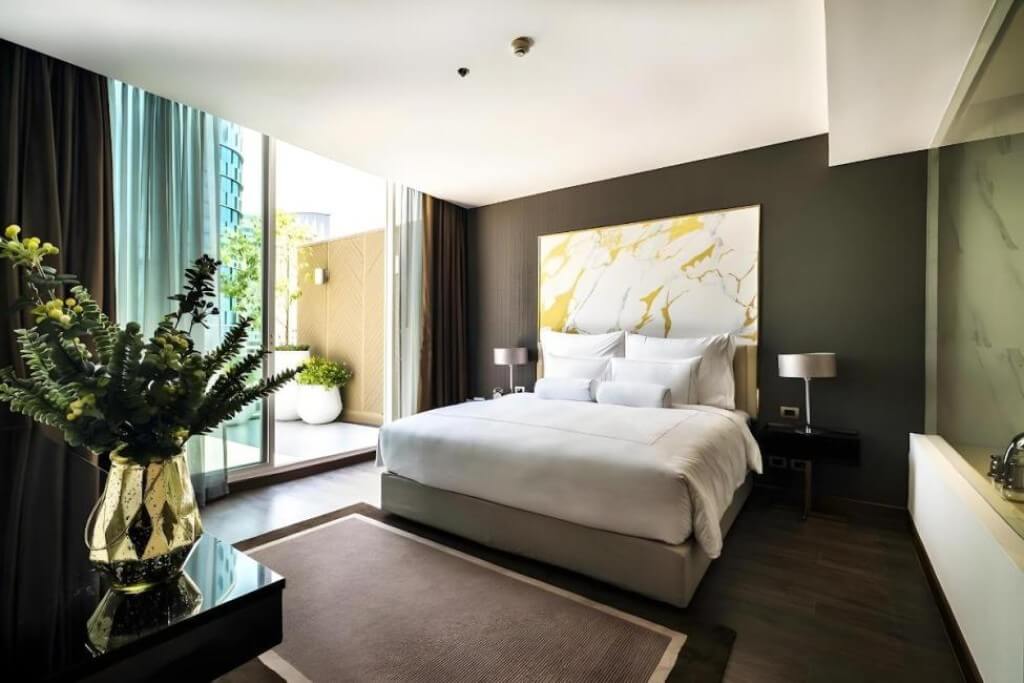 Private balcony accessible from bedroom at MUU Bangkok Hotel suite