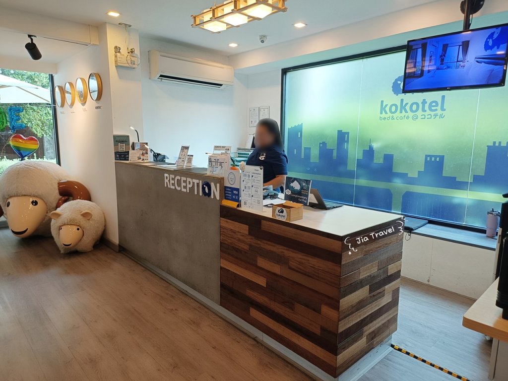 Kokotel Bangkok Sukhumvit 50 cozy lobby lounge corner with sheep decorations, warm lighting, and cushions