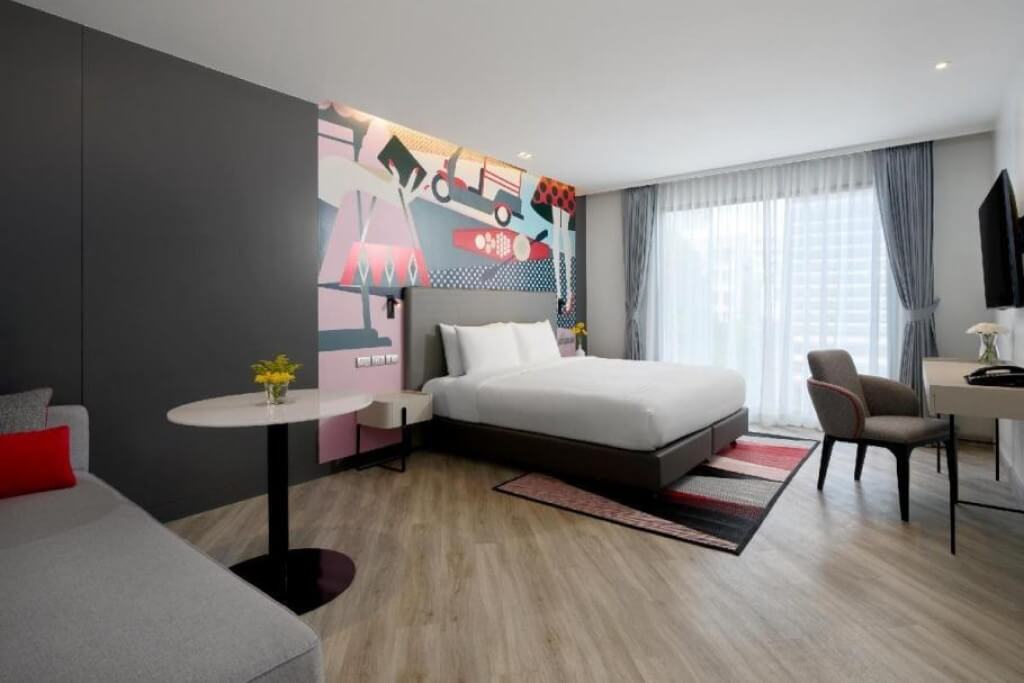 spacious modern room with gray base and colorful accents at Oakwood Studios Sukhumvit Bangkok