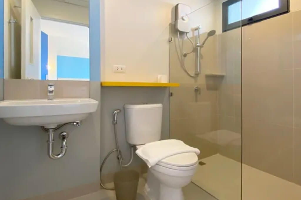 Hop Inn On Nut bathroom with sink toilet and shower area