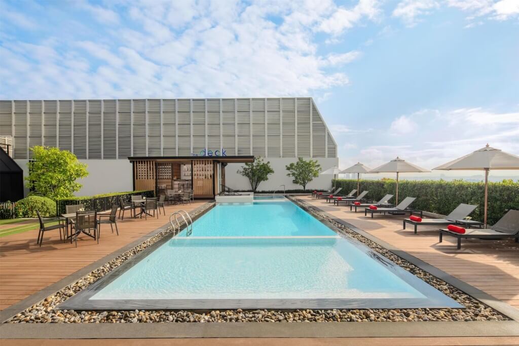 Avani Sukhumvit Bangkok outdoor swimming pool with city view and lounge chairs