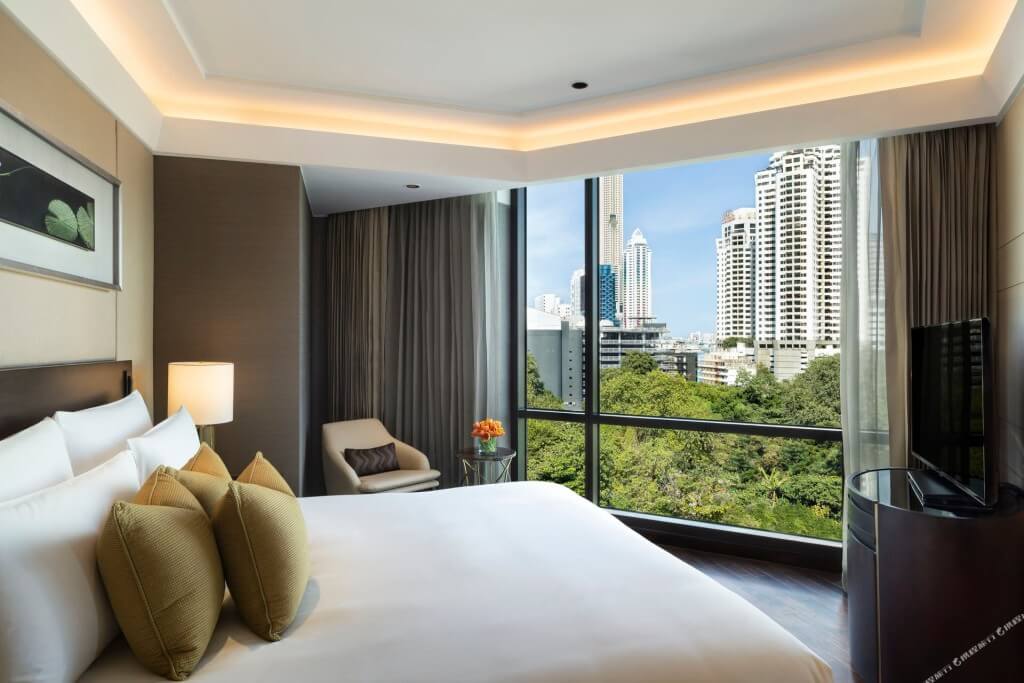 Siam Kempinski Hotel Bangkok two-bedroom family room master bedroom with calm luxury style and good window view
