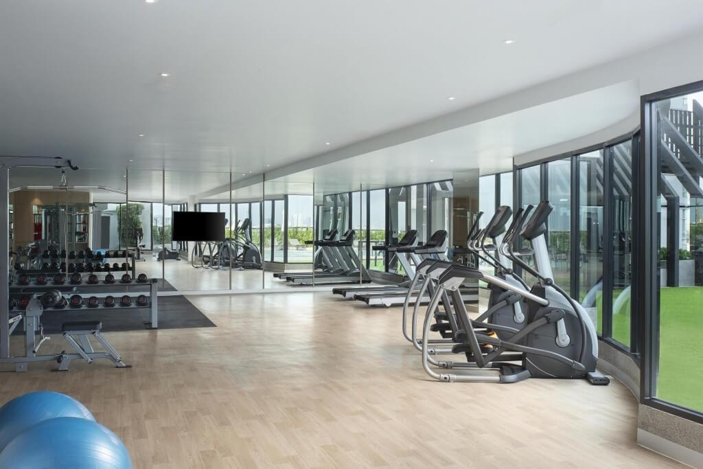 Avani Sukhumvit Bangkok spacious gym with natural light and variety of equipment