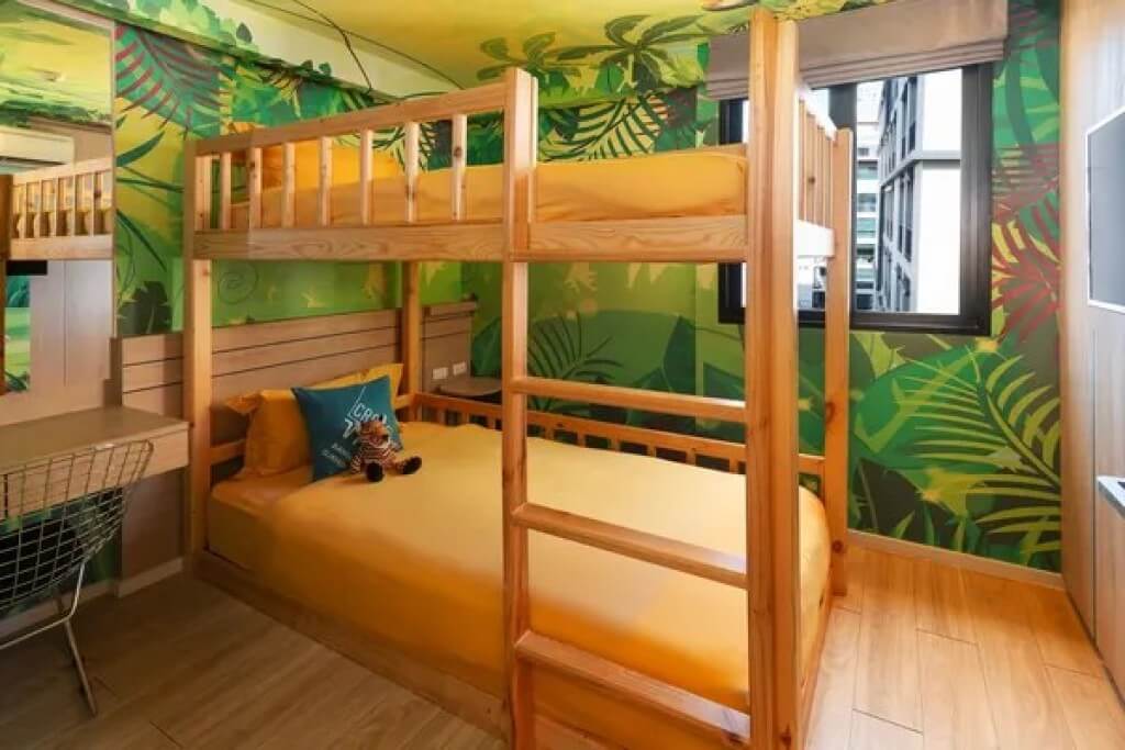 Forest themed mural wall art in kids bedroom of family suite at Cross Vibe Bangkok Sukhumvit hotel near BTS On Nut