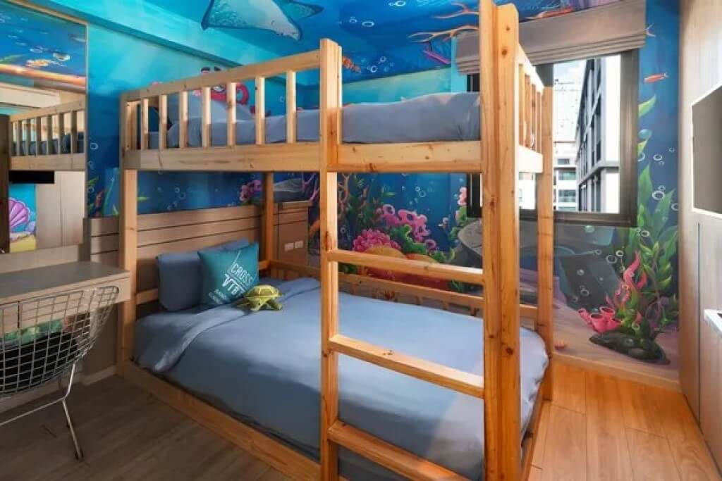 Ocean themed mural wall art in kids bedroom of family suite at Cross Vibe Bangkok Sukhumvit hotel near BTS On Nut