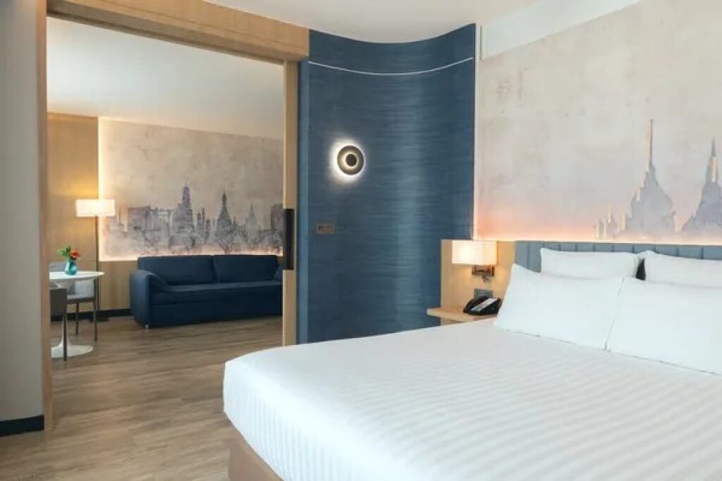 Novotel Bangkok Siam Square suite bedroom with king-size bed and cozy sleeping area