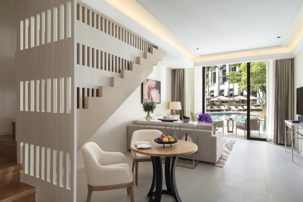 Siam Kempinski Hotel Bangkok duplex Kawana room level one view from dining to living room and pool