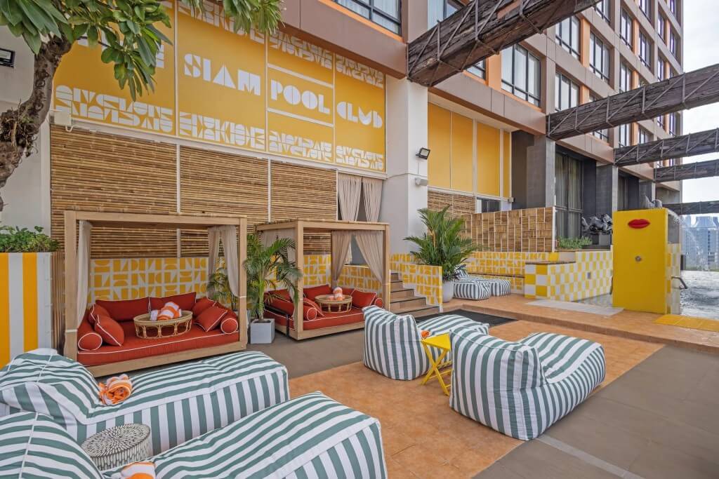 Siam Design Hotel Bangkok pool deck lounge chairs with city view